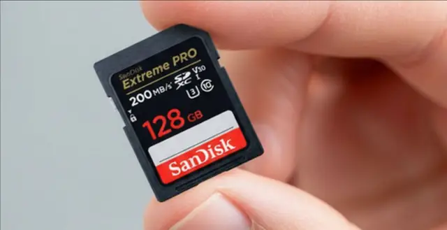 128GB MicroSD memory card held in hand