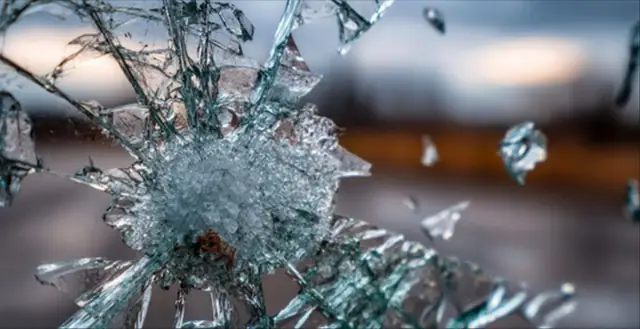 Close-up of shattered glass representing an impact event